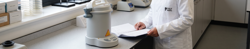 How do you maintain and operate an autoclave in a school biology laboratory?